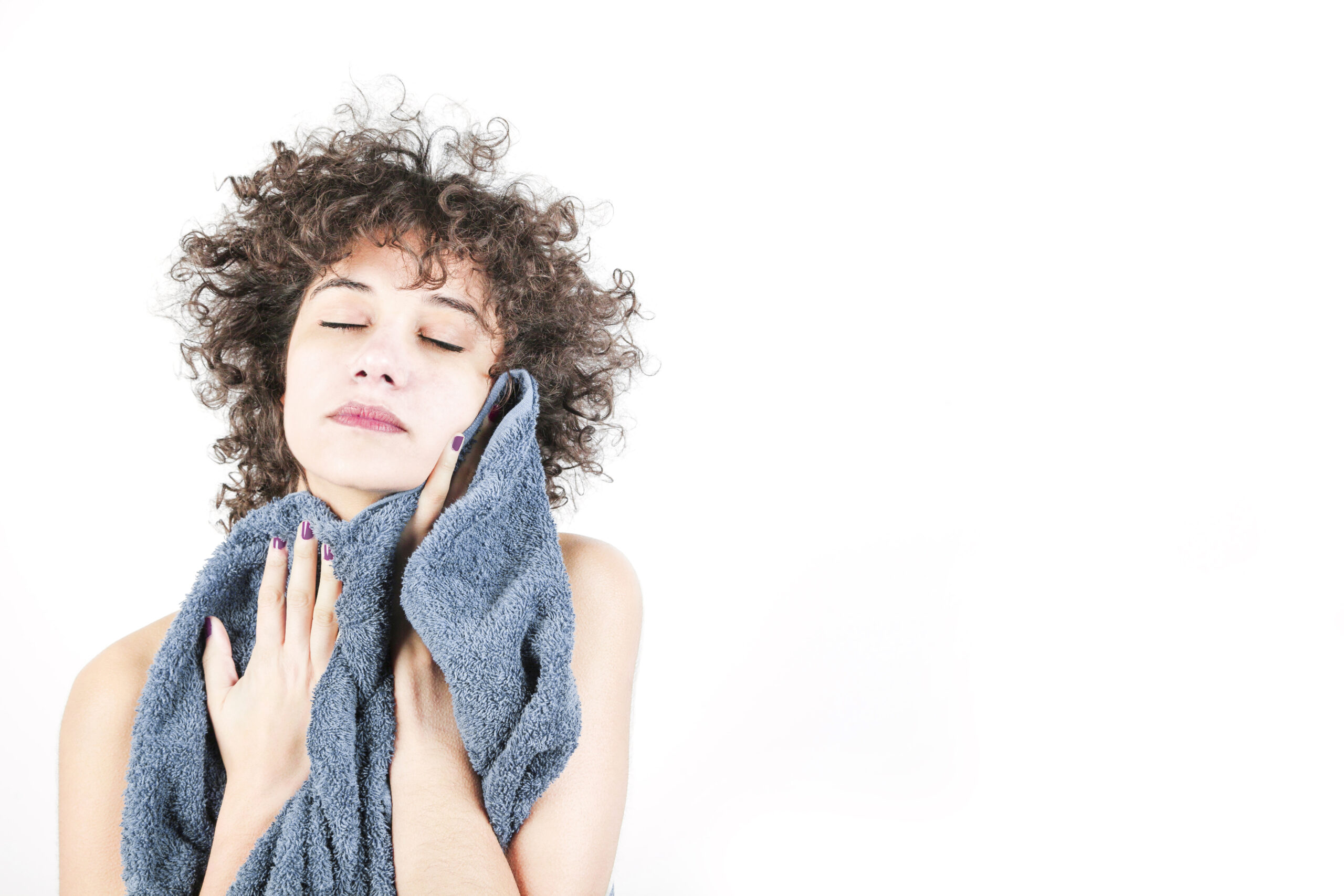 woman-wiping-herself-with-towel-against-white-background
