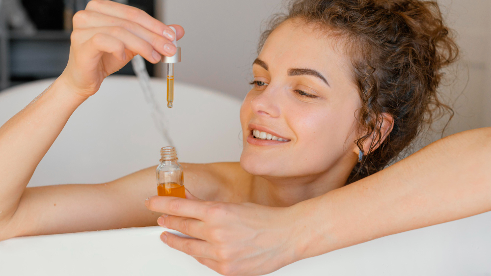 woman-relaxing-bathtub-with-serum